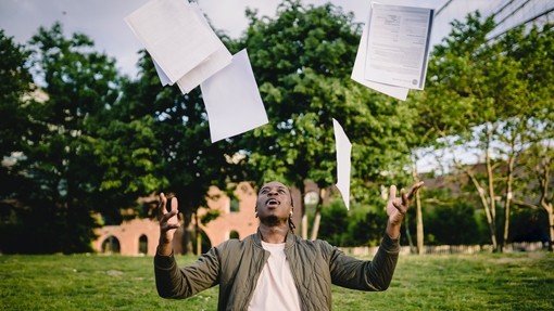 Man throwing paperwork in the air