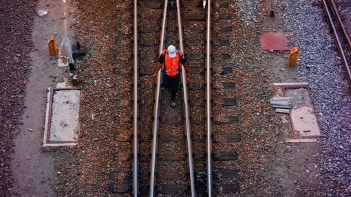 Rail worker on train tracks