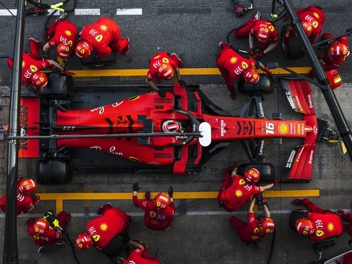 A Ferrari Formula 1 car in the pit stop with team attending