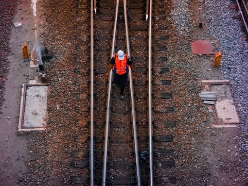 Rail worker on train tracks