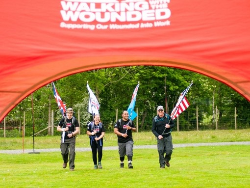 Representatives of the team walking with their flags