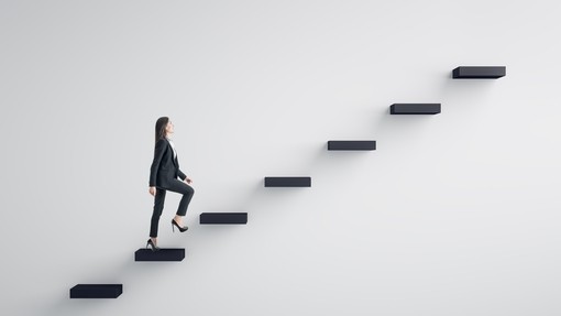 A female climbing the corporate ladder