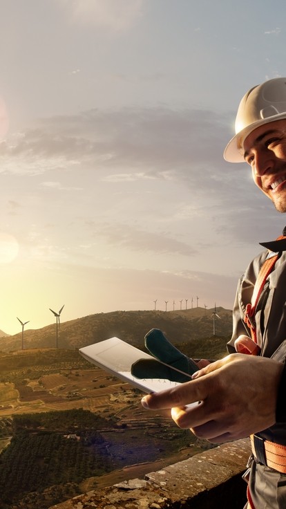 Smiling engineer, windfarm background