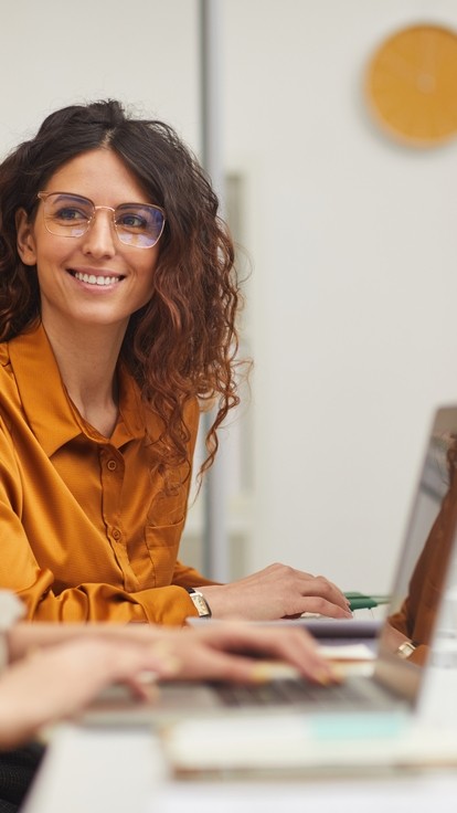 Two women working at laptops