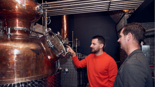 Seb Heeley showing Adrian Adair the distillery