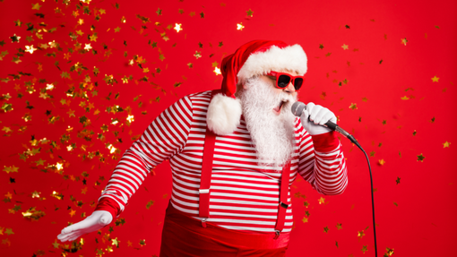 A man dressed as Santa Claus singing into a microphone