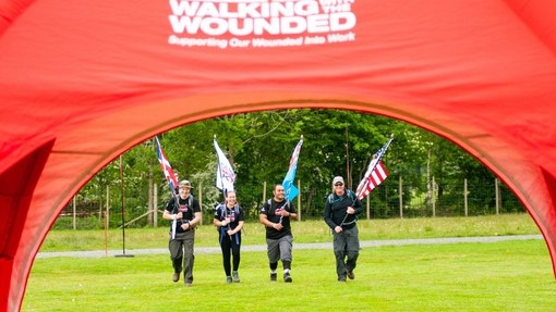 Representatives of the team walking with their flags