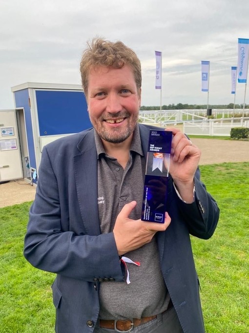 Dylan Edwards holding an award