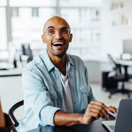 Bald man with glasses laughing